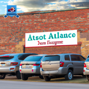 An image of a row of cars parked outside a brick building with a sign that reads "Auto Insurance Companies in Box Elder, South Dakota" in bold letters