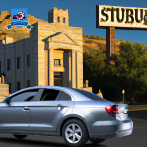 An image of a sleek silver sedan driving through downtown Scottsbluff, passing by iconic landmarks like the Scotts Bluff National Monument and local insurance company offices