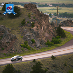 An image of a mountainous landscape in Billings, Montana, with a car driving down a winding road