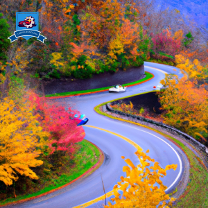 An image of a winding mountain road in Gatlinburg, Tennessee, lined with colorful autumn leaves and a small, affordable car driving through, symbolizing the search for the cheapest car insurance in the area